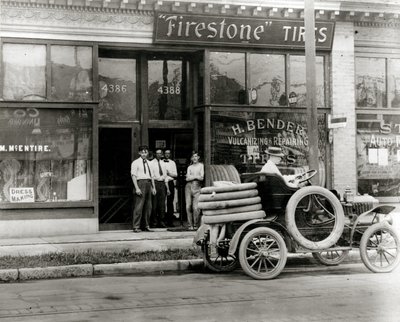 Men and Automobile Tire Repair Truck Gathered Outside the H. Bender Firestone Tire Dealership at 4388 Olive Street by Unknown